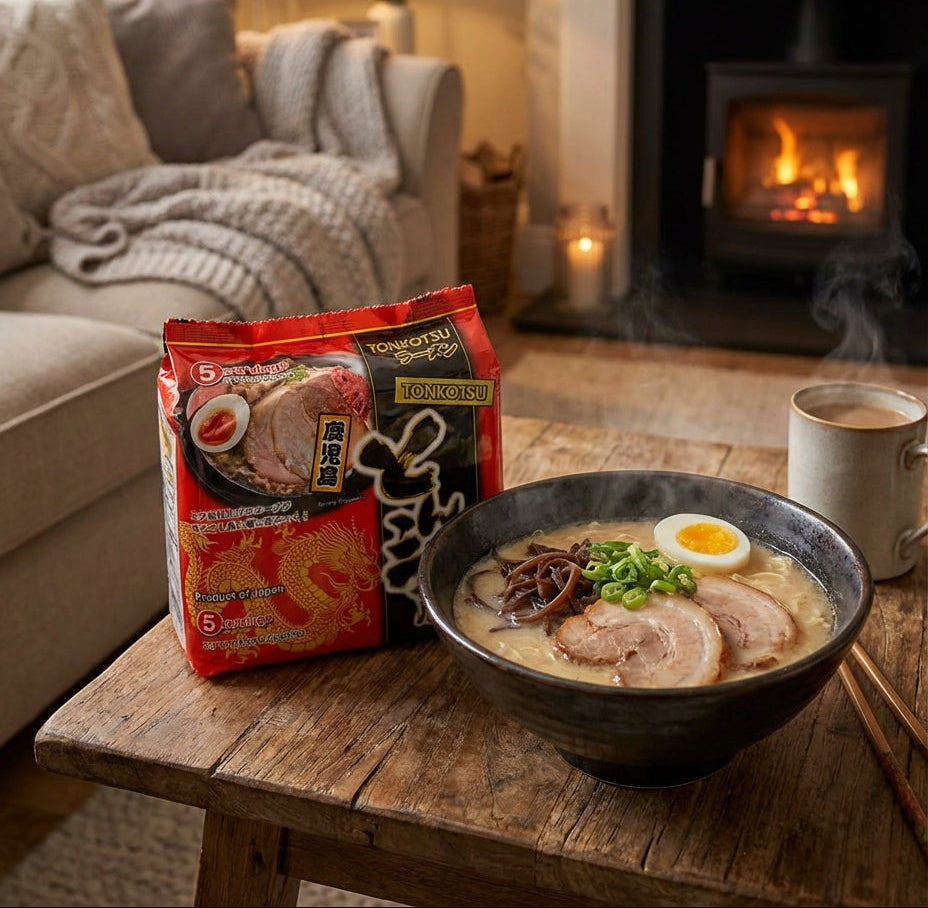 Noodle bowl with a package of noodles on a wooden table in a cozy living room with a fireplace.
