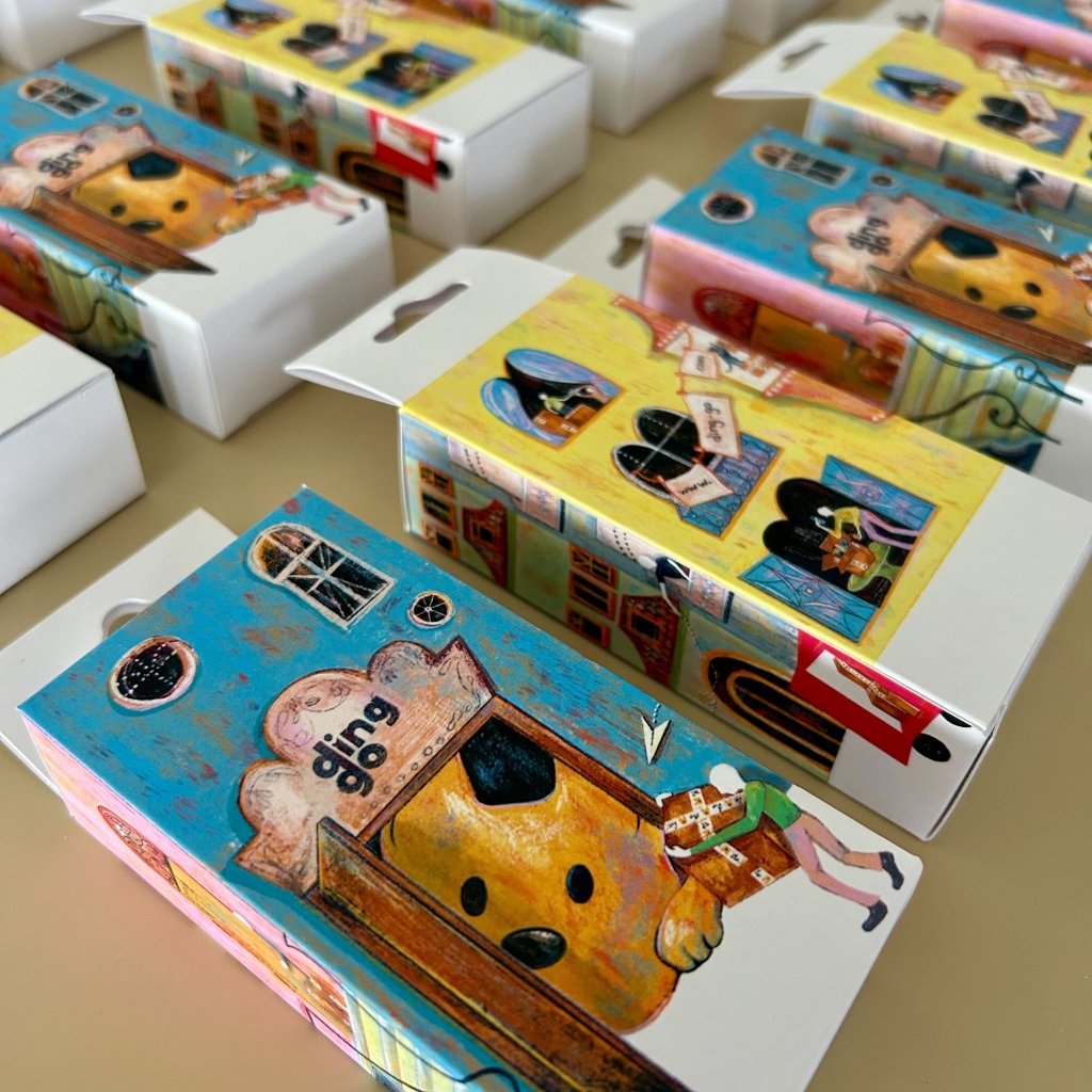 Collection of colorful phone cases with cartoon designs on a table.